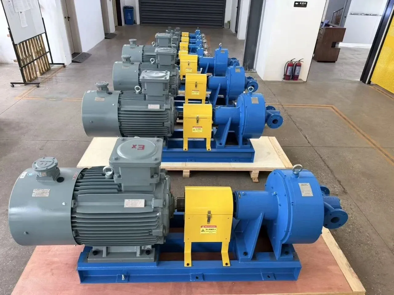EHIK skid-mounted pump set with a gray explosion-proof motor, yellow coupling guard and blue pump on one base.