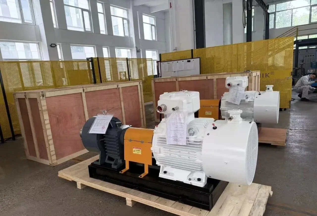 EHIK pump sets with white explosion-proof motors on wooden pallets beside wooden shipping crates.