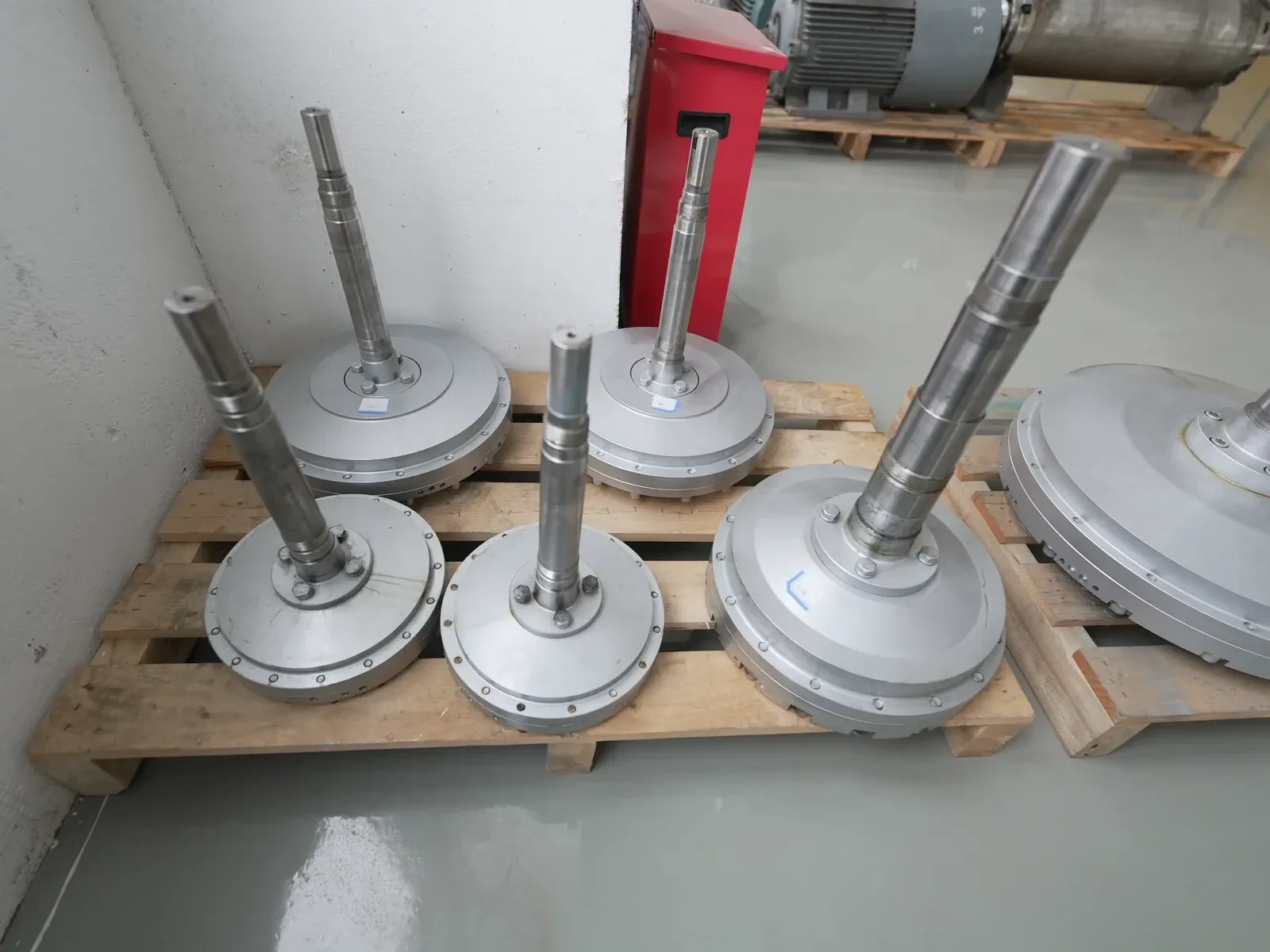 Several EHIK rotor assemblies with upright shafts arranged together on a workshop pallet.