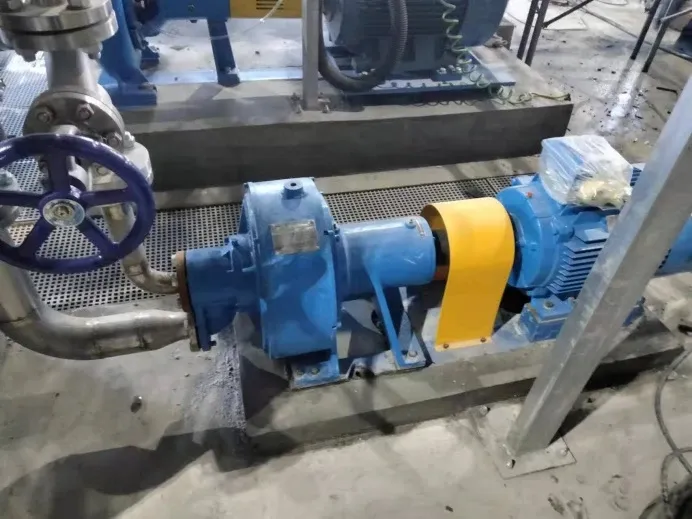 Close view of a blue water-jet cutting pump, yellow coupling guard, motor and piping at Xiawang Paper.